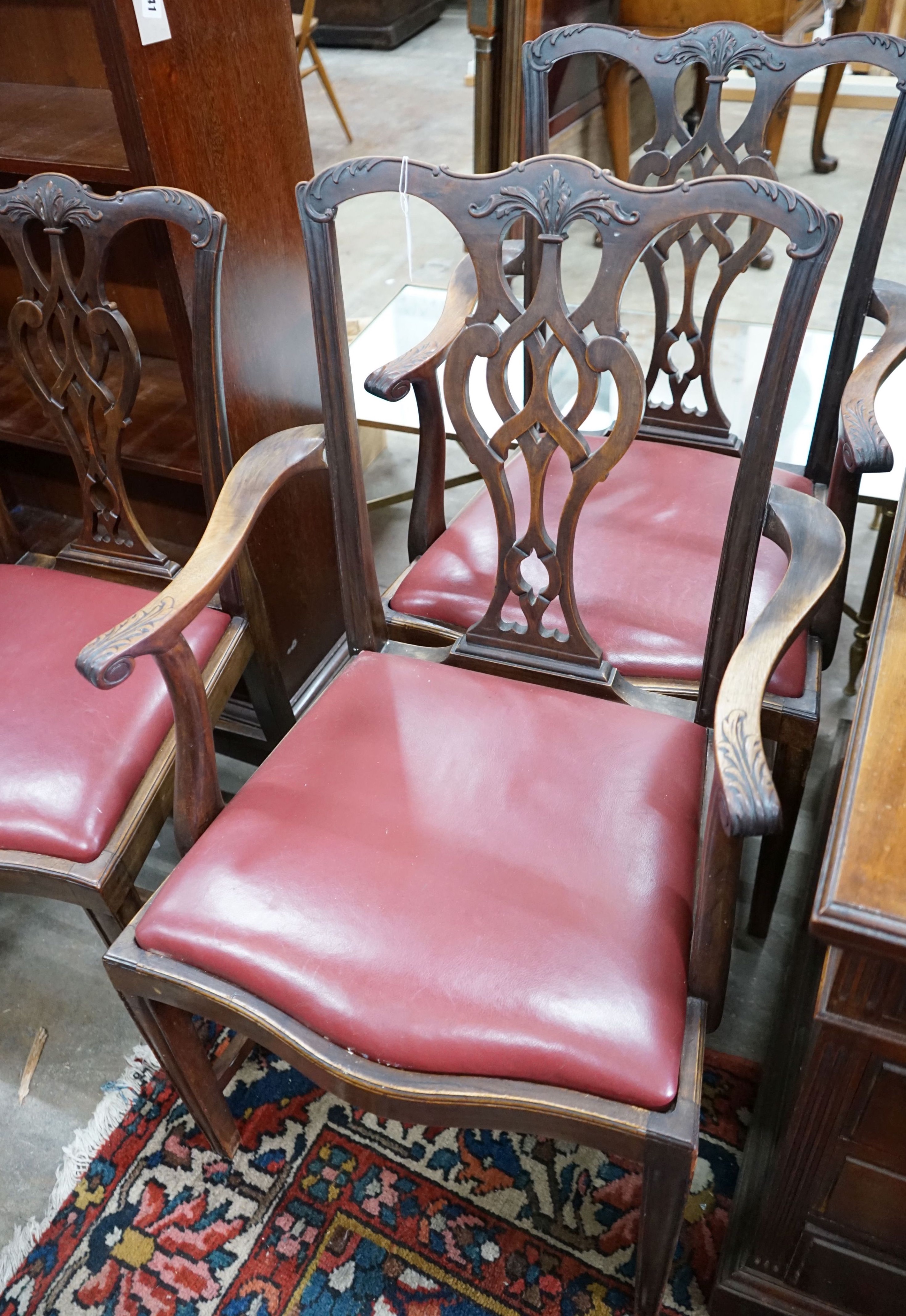 A set of eight Chippendale revival mahogany dining chairs with pierced splats, two with arms